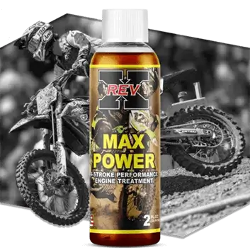 REV-X Max Power 2 fl. oz. engine treatment bottle with motocross riders and dirt bikes in the background.